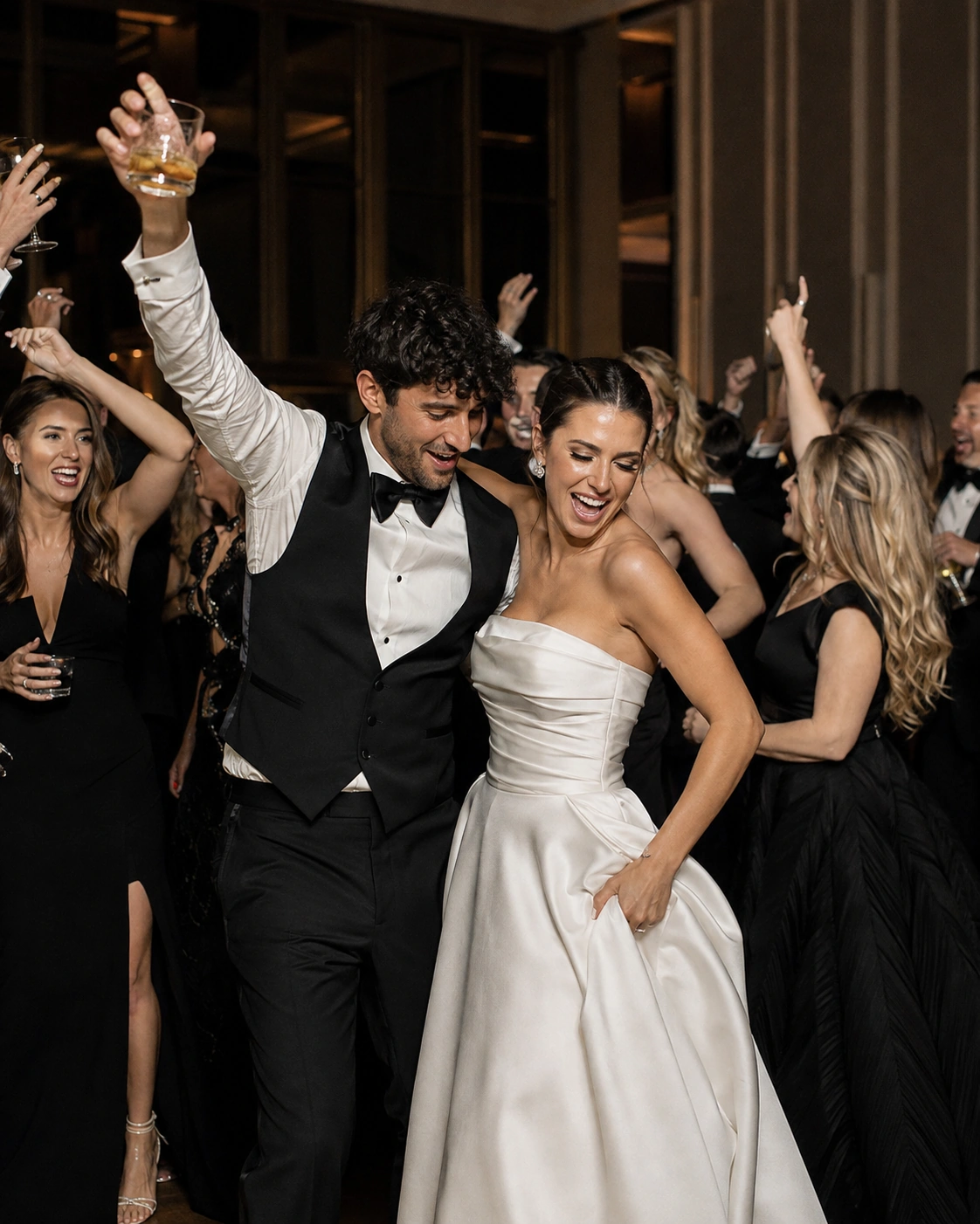 Luxury wedding guests celebrating on an elegant reception dance floor