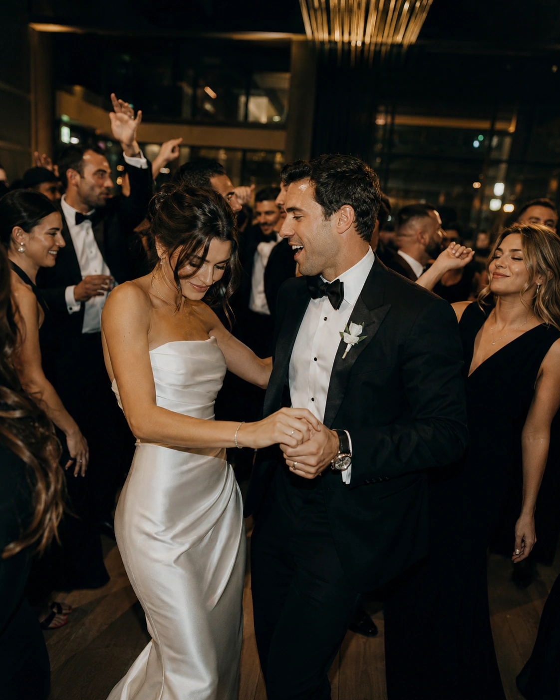 Elegant newlyweds celebrating with guests during a modern luxury wedding reception
