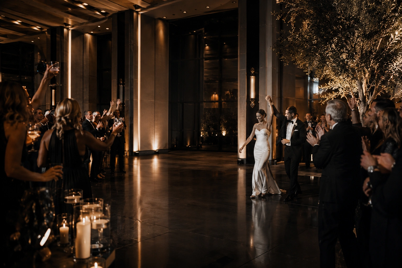 Newlyweds and guests celebrating during an upscale evening wedding reception